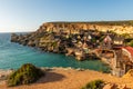 Il-Mellieha, Malta - Panoramic skyline view of the famous Popeye Village at Anchor Bay at sunset Royalty Free Stock Photo