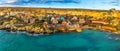 Il-Mellieha, Malta - Panoramic view of the famous Popeye Village at Anchor Bay at sunset Royalty Free Stock Photo