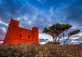 Il-Mellieha, Malta - St Agatha`s Red Tower at blue hour with tree and beautiful clouds