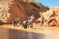Ilakaka, Madagascar - April 30, 2019: Group of unknown Malagasy men mining sapphire in surface lake mine with shovels on a sunny