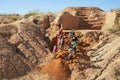 Ilakaka, Madagascar - April 30, 2019: Group of unknown Malagasy men mining sapphire in surface mine, by moving ground with shovels