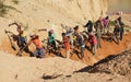 Ilakaka, Madagascar - April 30, 2019: Group of unknown Malagasy men mining sapphire in surface mine, by moving ground with shovels