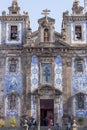 Ildefonso church with tourists in Porto, Portugal. Traditional portuguese exterior with ceramic azulejo tiles.