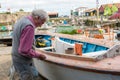 Marine carpenter restores a boat on Robert Leglise shipyard in Port Le Chateau d`Oleron, France