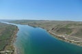 The Ili river in Almaty region flows along the hilly territory. The view from the helicopter Royalty Free Stock Photo