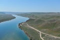 The Ili river in Almaty region flows along the hilly territory. The view from the helicopter Royalty Free Stock Photo
