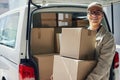 Ill be making a delivery stop by you soon. Portrait of a courier moving boxes in a delivery van. Royalty Free Stock Photo