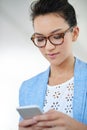 Ill be in the office today. an attractive young woman using a cellphone in an office. Royalty Free Stock Photo