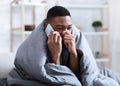 Ill Black Man Calling Doctor Having Runny Nose Sitting Indoors Royalty Free Stock Photo