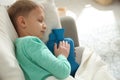 Ill boy with hot water bottle suffering from cold at home Royalty Free Stock Photo