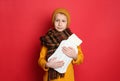 Ill boy with hot water bottle suffering from cold on red background Royalty Free Stock Photo