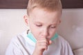 Ill boy suffering from cough in bed at home Royalty Free Stock Photo