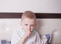 Ill boy suffering from cough in bed at home Royalty Free Stock Photo