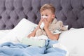 Ill boy suffering from cough in bed Royalty Free Stock Photo