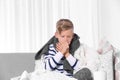 Ill boy suffering from cough on sofa Royalty Free Stock Photo