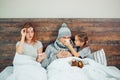 Sick family at home together lying on bed Royalty Free Stock Photo