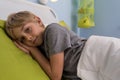 Ill child lying in hospital bed Royalty Free Stock Photo