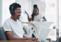 When Ill do it later becomes never. a young man using a laptop while his wife irons clothing in the background. Royalty Free Stock Photo