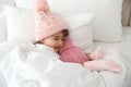 Ill girl with hot water bottle suffering from cold in bed at home Royalty Free Stock Photo