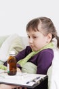 Ill girl lying in bed in front different medicine Royalty Free Stock Photo