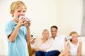 Ill give her something to listen to. A little boy shouting loudly into a tin can connected to another that his sister is Royalty Free Stock Photo