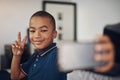 Ill give you a few tips on how to be cool. a young boy taking a selfie at home. Royalty Free Stock Photo