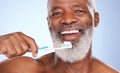 Ill give you toothache just from kissing me. Studio portrait of a mature man brushing his teeth against a blue Royalty Free Stock Photo