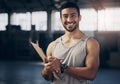 Ill help you fill out a membership form. Portrait of a muscular young man writing notes on a clipboard while working in Royalty Free Stock Photo