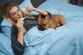 Sick woman taking her body temperature in bed Royalty Free Stock Photo