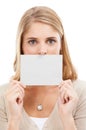 Ill let your message do the talking. Studio portrait of a woman holding a blank sign in front of her mouth isolated on Royalty Free Stock Photo