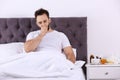 Ill man suffering from cough in bed Royalty Free Stock Photo