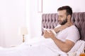 Ill man suffering from cough in bed Royalty Free Stock Photo