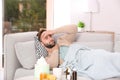 Ill man suffering from cough on sofa Royalty Free Stock Photo