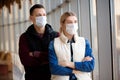 Ill man and woman feeling sick, wearing protective mask against transmissible infectious diseases and as protection against the