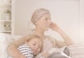 Mother after chemotherapy embracing child Royalty Free Stock Photo