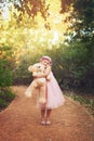 Ill never leave leave him behind. a happy little girl holding a teddy bear and looking at the camera while standing in Royalty Free Stock Photo