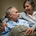 Ill old man lying bed with wife Royalty Free Stock Photo