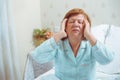 Worried old woman has headache at home. Royalty Free Stock Photo