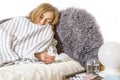 Ill sick woman lies in bed blowing her nose, coughing. Concept diseases of flu virus, colds, seasonal allergies, coronavirus