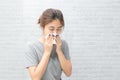 Ill upset young woman blowing nose got fever caught cold sneezing in tissue