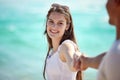 Ill walk hand in hand with you forever. a young couple enjoying a day at the beach. Royalty Free Stock Photo