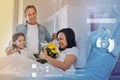 Ill woman feeling pleased while her relatives bringing her flowers Royalty Free Stock Photo