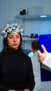 Ill woman listening neurological doctor looking at clipboard