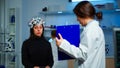 Ill woman listening neurological doctor looking at clipboard