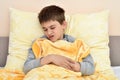 Ill young boy sitting in bed                                 6198 Royalty Free Stock Photo