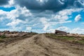 Illegal cutted pine logs near a forest road with dramatic sky Royalty Free Stock Photo