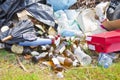 Illegal dumping with bottles, boxes and plastic bags abandoned i Royalty Free Stock Photo