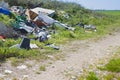 Illegal dumping with bottles, boxes and plastic bags abandoned in nature Royalty Free Stock Photo