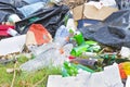 ILLEGAL DUMPING with bottles, boxes and plastic bags abandoned in nature Royalty Free Stock Photo