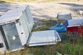 Illegal dumping with cardboard boxes, plastic bags and domestic appliances abandoned in nature